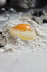ingredients for cookies. broken eggs uphill with flour