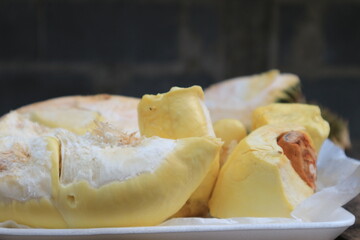 Durian riped and fresh with yellow colour on wooden table.