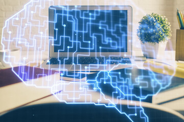 Double exposure of work space with computer and human brain drawing hologram. Brainstorm concept.