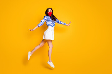 Fototapeta na wymiar Full length profile side photo of shocked woman go walk jump copyspace wear medical mask white blue striped shirt shoes isolated over bright shine color background