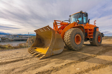 Obraz na płótnie Canvas Excavator moving earth on a road construction works