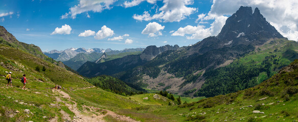 Naklejka na ściany i meble two hiker women in path of Pic du Midi Ossau in french Pyrenees mountains