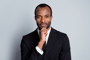 Portrait of cool intelligent afro american man wealthy company owner broker touch hand chin decide...