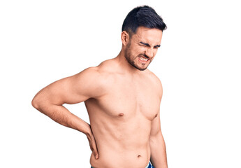 Fototapeta premium Young handsome man wearing swimwear suffering of backache, touching back with hand, muscular pain