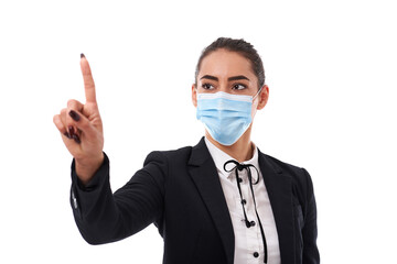 Young businesswoman in face mask pointing to copyspace