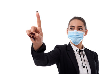 Young businesswoman in face mask pointing to copyspace