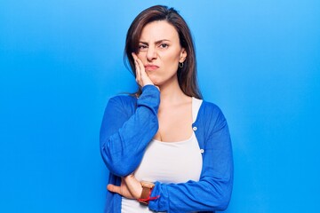 Young beautiful woman wearing casual clothes thinking looking tired and bored with depression problems with crossed arms.