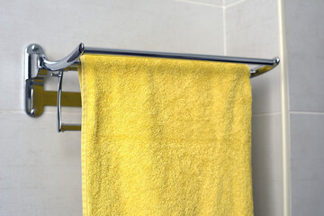 shelf with a yellow towel in the bathroom