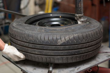 Mechanic changing car tire fitting. Wheel tyre repairing.