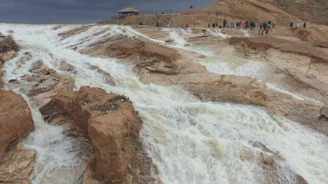 Flash Flood in the desert Waterfall- Aerial Footage Swifts flying around Hayon reservoir ,Wadi Nahal Hayon, Drone shot, Arava Desert, Israel