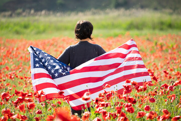 Patriot woman holding the american flag on the 4th of July