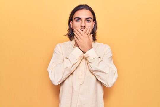 Young handsome man wearing business clothes shocked covering mouth with hands for mistake. secret concept.