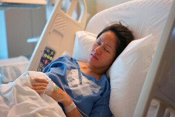 Asian Chinese Woman patient lying in the hospital bed calm and peaceful