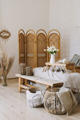 Comfortable bedroom in bohemian interior style with furnishing