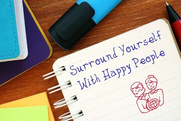 Motivation concept about Surround Yourself With Happy People with sign on the piece of paper.