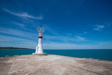 Lighthouse on the blue sky background. Wide angle wiew