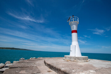 Lighthouse on the blue sky background. Wide angle wiew