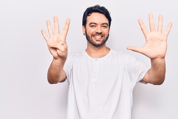 Young hispanic man wearing casual clothes showing and pointing up with fingers number nine while...