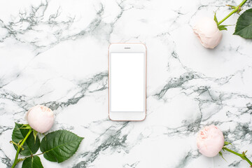 White roses with mobile phone on white and black marble background with copyspace