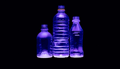 Purple illumination of clear plastic recyclable water bottle