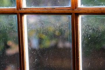 Dirty windows in wooden frame