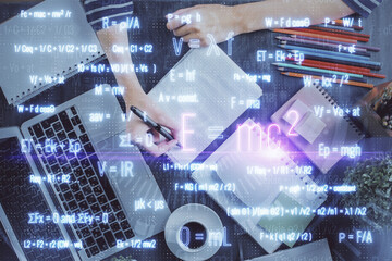 Science formula hologram over woman's hands taking notes background. Concept of study. Double exposure