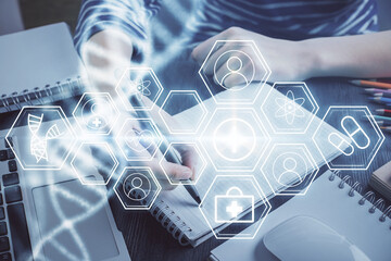 DNA theme hologram over woman's hands writing background. Concept of education. Double exposure