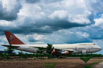 Nakhon Pathom, Thailand - June, 09, 2020 : The old commercial aircraft was discharged with a stormy sky at Nakhon Pathom, Thailand