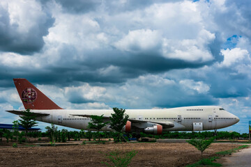 Nakhon Pathom, Thailand - June, 09, 2020 : The old commercial aircraft was discharged with a stormy sky at Nakhon Pathom, Thailand