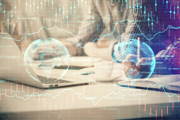 Multi exposure of forex chart with man working on computer on background. Concept of market analysis.