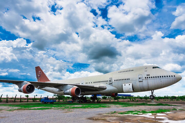 Fototapeta na wymiar Nakhon Pathom, Thailand - June, 09, 2020 : The old commercial aircraft was discharged with a stormy sky at Nakhon Pathom, Thailand