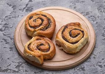 Tasty buns with raisins on a grey concrete table. fresh bakery. breakfast. bread. top view