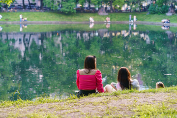 Moscow street life in summer hot day. Coronavirus quarantine is over. People go for a walk. They...