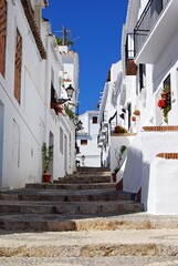 View along a typical street in the whitewashed village, Frigiliana, Andalusia, Spain.