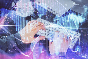 Double exposure of businessman working on laptop on background. International business hologram in front. Concept of success.