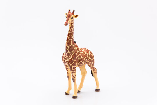 close up of a giraffe from a plastic toy isolated on a white background