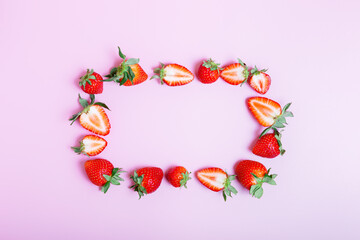  rectangular frame made of fresh tasty strawberries on a lilac background. healthy eating concept. Beautiful background or greeting card. copy space, flat lay, border, flat lay.