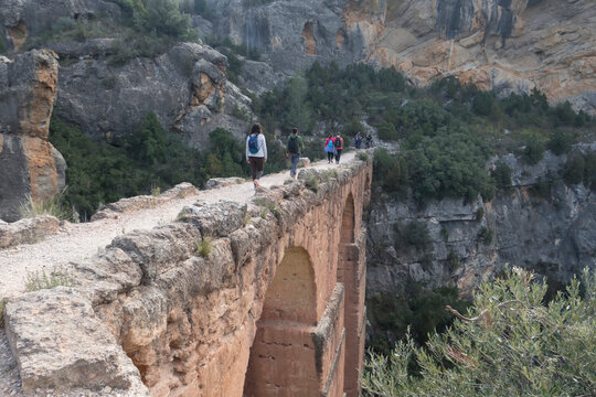 group of hikers walking along the water route in chelva