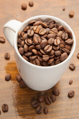 A conceptual image of bean to cup coffee, with a coffee mug full of beans.