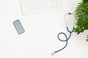 Doctor's workspace: keyboard, phone stethoscope.