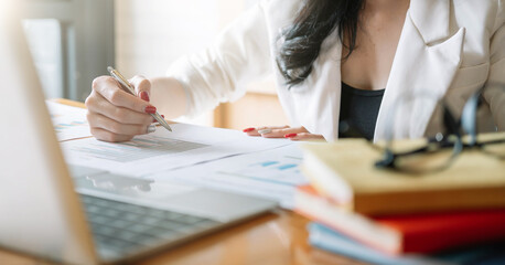 close up business woman working with financial report