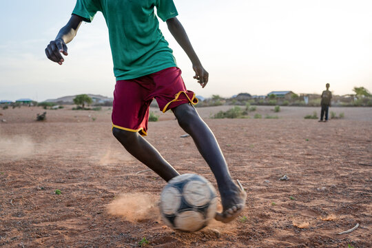 African boy plays football in Melkadida refugee camp, Dollo Ado, Somali Region,  Ethiopia