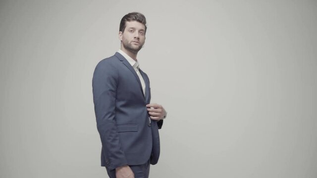Young handsome businessman isolated on gray background