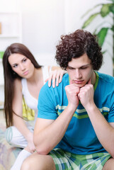 Angry and unhappy young couple in bed