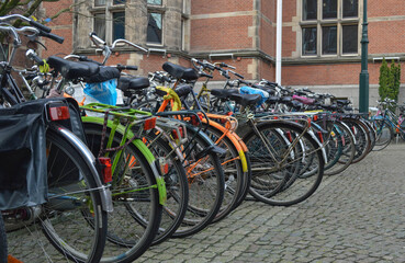 Fototapeta na wymiar Bicycle parking near brick building