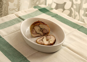 Freshly homemade chicken or turkey meat roll baked in the oven is on the ceramic pan. Concept of cooking of healthy food at home. Step-by-step