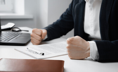 Cropped view Angry businessman with closed fists on the table.