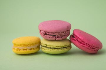Closeup of french traditional macarons on green background