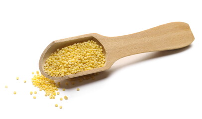 Peeled yellow millet seeds with wooden spoon, organic food product isolated on white background