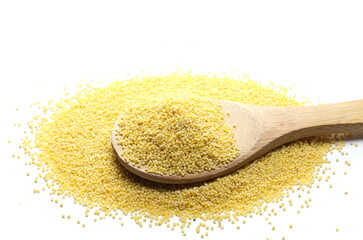 Peeled yellow millet seeds with wooden spoon, organic food product isolated on white background